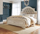 Realyn Queen Upholstered Panel Bed with Mirrored Dresser